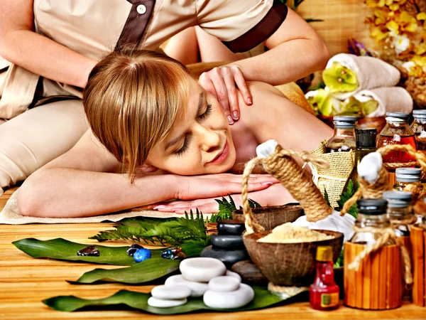 Woman getting herbal ball massage .