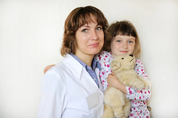 Young female doctor with a cute little patient