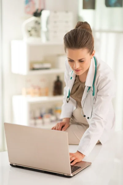 Medical woman working on laptop